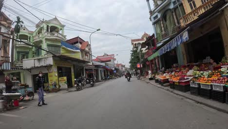 Urban-area-of-Vietnam-while-driving-motorbike,-POV