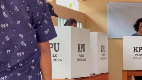 Indonesian-people-standing-inside-voting-booth-for-president-election