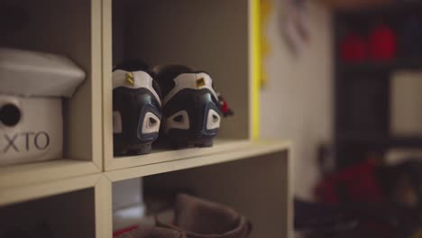 Adult-man-taking-up-cycling-boots-form-his-cupboard-for-cycling