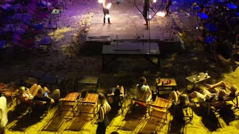 Thai-beach-bar-entertaining-tourist-drinking-at-the-beach-with-fire-show