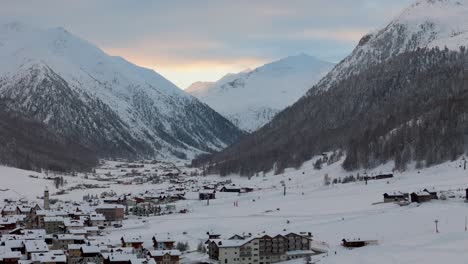 Stunning-Livigno-Alps-drone-video:-snow-peaks,-city-and-mountain-town,-ideal-for-high-quality-winter-and-tourism-ads