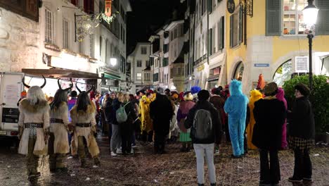 People-Celebrating-carnival-event-outdoor-at-night-on-road-in-swiss-city