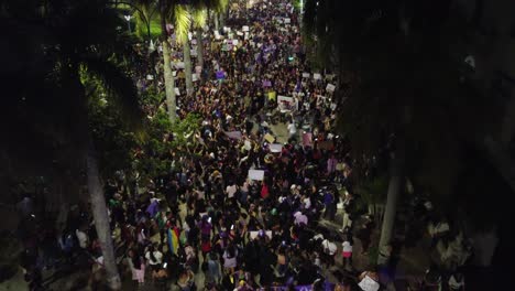 Night-aerial-flyover:-People-celebrate-Women's-Day-in-Santa-Cruz,-BOL