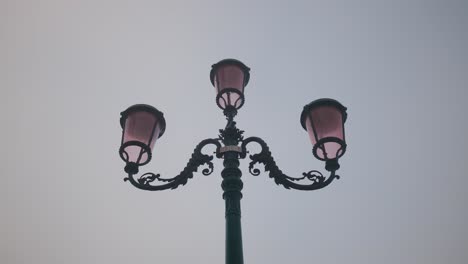 Ornate-street-lamps-against-dusk-sky-in-Venice