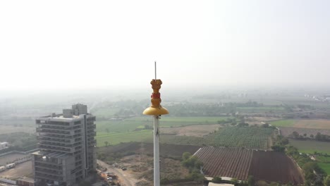 rajkot-atal-lake-drone-view-Camera-is-rotating-around-Ashok-Chakra-but-a-big-lake-is-also-visible,-Rajkot-New-Race-Course,-Atal-Sarovar