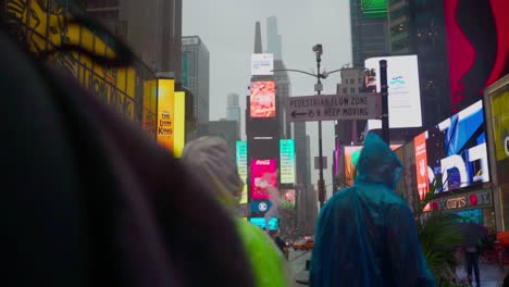 Busy-evening-commute-in-pouring-rain-in-the-garish-LED-illuminated-Times-Square-district
