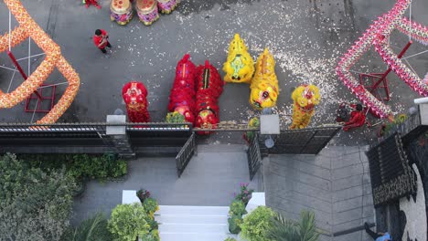 Year-of-Dragon-dance-performance-in-a-small-street-in-Ho-Chi-Minh-City,-Vietnam-from-top-down-view