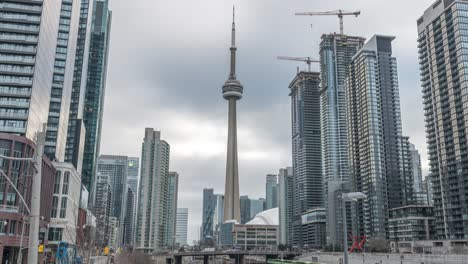 Trains-and-street-traffic-by-skyscrapers-in-central-Toronto,-timelapse