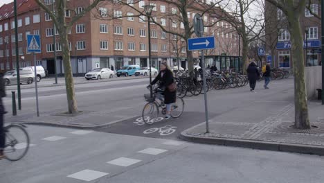 Cyclist-Crossing-On-The-Bike-Paths-In-The-City-Of-Malmo,-Sweden