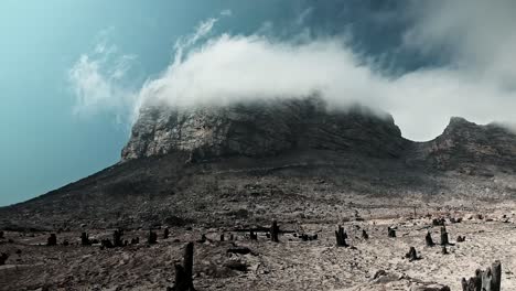 Clouds-move-over-a-huge-mountain-cliff-after-a-wild-fire-has-burnt-the-earth