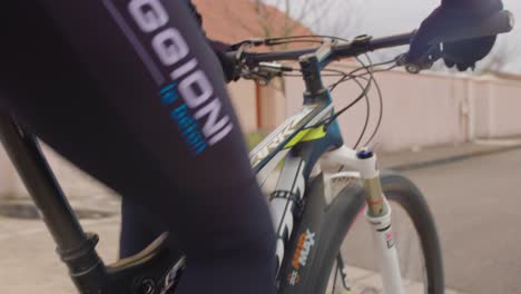 Closeup-view-of-a-French-man-cycling-on-streets-of-France-during-daytime