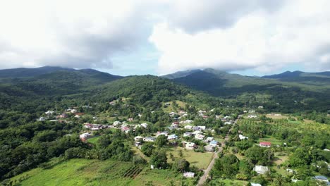 Settlements-With-Lush-Mountain-Ridge-In-The-Background-In-Guadeloupe,-France