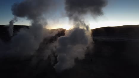Sunrise-aerial-orbits-geologic-geysers-hot-steam-at-Sol-de-Manana,-BOL