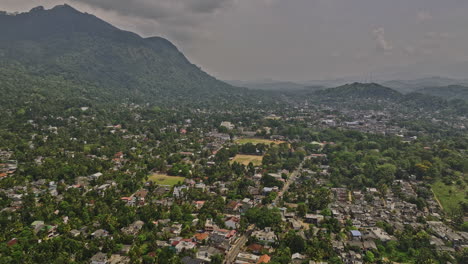Matale-Sri-Lanka-Aerial-v2-drone-flyover-Kumbiyangoda-road-capturing-the-scenic-townscape-of-Hulangamuwa-suburb,-residential-houses-and-hillside-cityscape-views---Shot-with-Mavic-3-Cine---April-2023