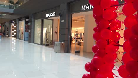 POV-walk-through-a-heart-shaped-balloon-arch-in-a-mall