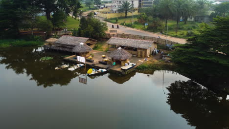 Aerial-view-away-from-a-restaurant-on-the-coast-of-Lac-Muncipal-in-Ebolowa,-Cameroon