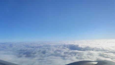 Aerial-view-of-Cloudscape-in-dawn-through-the-airplane-window