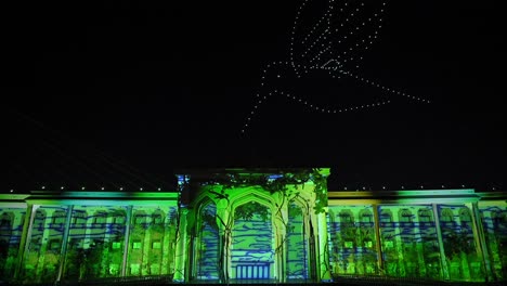 During-the-13th-edition-of-the-Sharjah-Light-Festival-2024,-lights-and-drones-illuminate-the-Sharjah-Police-Headquarters-building,-United-Arab-Emirates