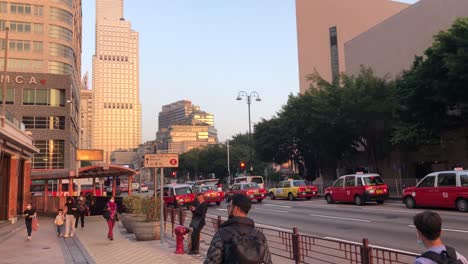 People-walking-in-the-streets-of-Tsim-Sha-Tsui-near-the-entrance-to-the-MTR,-Hong-Kong