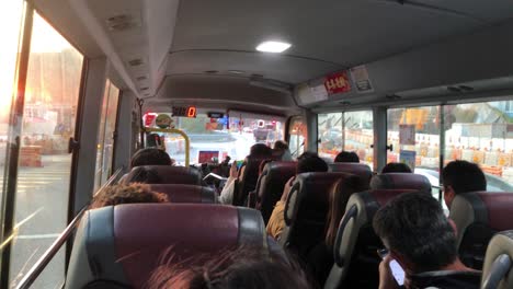 POV-on-a-packed-mini-bus-travelling-through-Hong-Kong