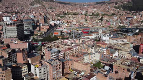 Aerial-follows-cable-car-route-over-mountain-city-of-Oruro,-Bolivia