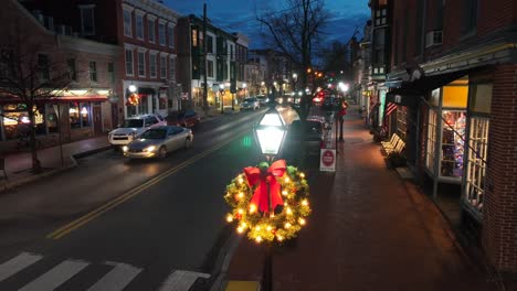 Small-town-shops-and-lamp-post-decorated-with-lights-and-wreaths-for-Christmas