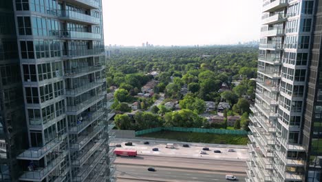 New-condo-high-rise-towers-overlooking-busy-highway-traffic-and-urban-city-neighborhood