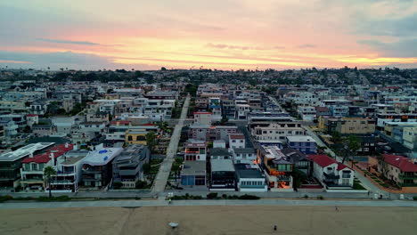 Aerial-tracking-shot-of-the-Manhattan-Beach-district,-sunset-in-Los-Angeles,-USA