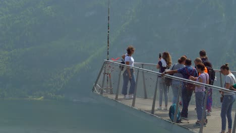 Beautiful-Young-Red-Hair-Woman-Takes-Pictures-on-Hallstatt-Skywalk