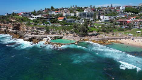 Bronte-Beach-With-Tourists-Enjoying-In-Summer,-Sydney,-NSW,---Aerial-Shot