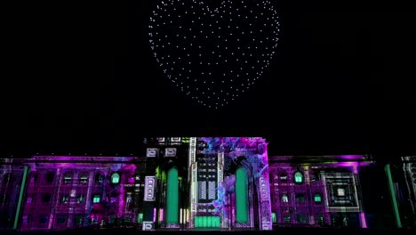 During-the-13th-edition-of-the-Sharjah-Light-Festival-2024,-lights-and-drones-illuminate-the-Sharjah-Police-Headquarters-building,-United-Arab-Emirates