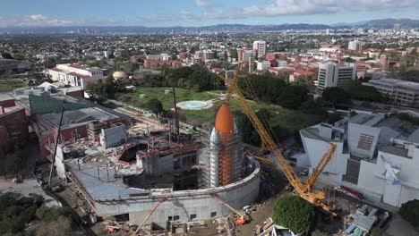 Display-of-Space-Shuttle-at-Los-Angeles-museum-under-construction-scaffolding,-aerial-orbit