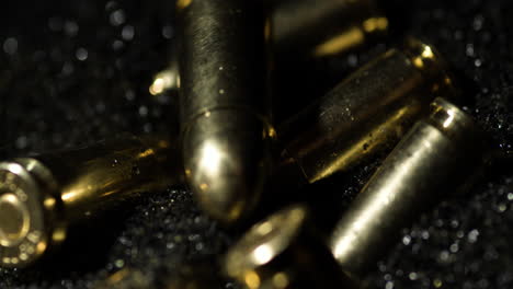 Macro-detail-shot-of-9×19mm-Parabellum-bullets-in-slow-motion-falling-on-gunpowder