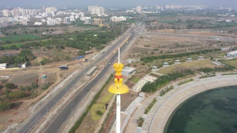 Rajkot-Atal-lake-drone-view-drone-close-up-shot-back-side-mouth-lake-and-around-ashok-chakra-there-are-many-gardens-around,-Rajkot-New-Race-Course,-Atal-Sarovar