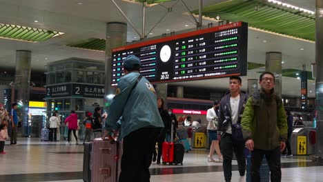 Passengers-traveling-with-luggages-access-airport-connecting-networks-at-arrival-and-departure-hall-of-Taoyuan-High-Speed-Rail-Station,-Taiwan-tourism,-handheld-motion-shot