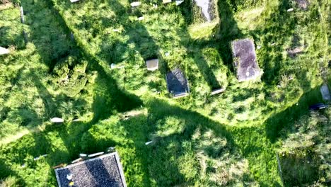 Top-down-aerial-drone-shot-of-the-ruins-of-Aughadown-Graveyard-along-the-River-llen-in-West-Cork