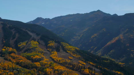 Aspen-Snowmass-Mountain-Maroon-Bells-Pyramid-Peak-Colorado-summer-fall-autumn-colors-aerial-drone-cinematic-ski-trails-beautiful-stunning-blue-sky-mid-day-sunny-circle-movement-right-parallax-zoom-out