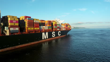 Close-up-shot-of-a-large-MCS-container-ship-in-blue-calm-waters-on-a-bright-day