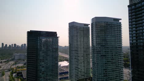 Glass-condominiums-reflecting-light-during-morning-sunrise-in-urban-city-development