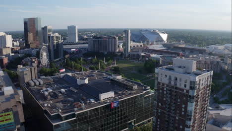 Atlanta-City-during-sunny-day-with-high-rise-buildings,-ferris-wheel-and-Mercedes-Benz-Arena-in-background,USA