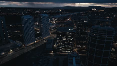 Downtown-with-modern-business-offices-and-apartment-houses-at-night---aerial-drone-view