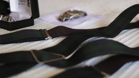 Elegant-suspenders-on-textured-fabric-backdrop