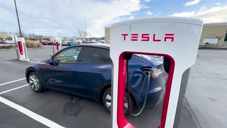 Tesla-Model-Y-charging-its-battery-at-a-Supercharger