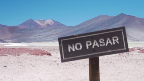 No-Trespassing-Wooden-Sign-near-a-Multicolored-Mountain-in-the-Desert