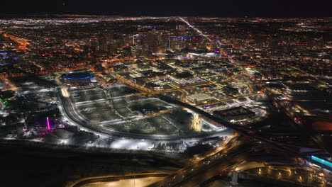 Downtown-Denver-i25-traffic-snowy-winter-evening-night-city-lights-landscape-aerial-drone-cinematic-anamorphic-highway-Colorado-Mile-High-DU-Metro-Eltiches-Empower-Field-Ball-Arena-reveal-pan-forward