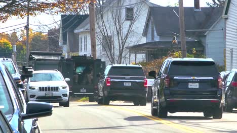 Swat-team-and-police-vehicles-rushing-in-response-to-mass-shooting-in-Lewiston,-USA