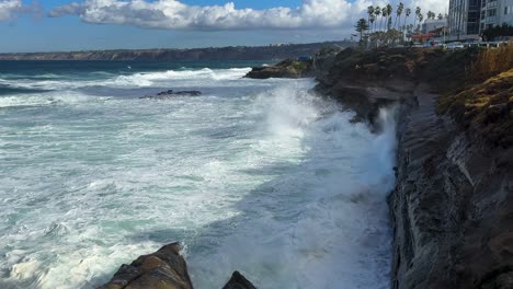 King-tide-at-La-Jolla-Cove-view-over-large-seascape-with-ocean-waves-smashing-and-crashing-on-clliffs
