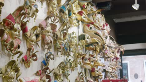 Opulent-gold-Venetian-masks,-Ca'-Macana-showcase.-Italy