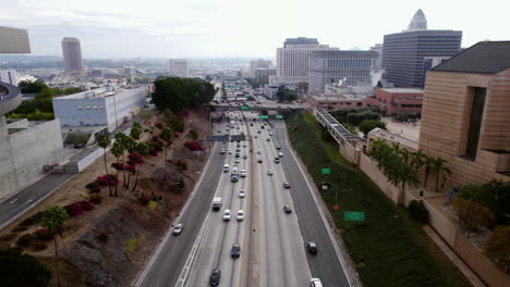 Drone-Shot-of-US-101-Highway-Traffic-in-Downtown-Los-Angeles-USA,-Santa-Ana-Fwy-and-County-Court-Buildings