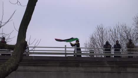 Frau-Hisst-Bei-Palästina-Protest-Die-Palästinensische-Flagge-Auf-Einer-Brücke